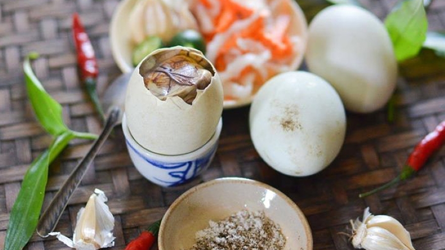 Balut in Vietnam (hot vit lon) boiled duck egg at a Saigon street stall