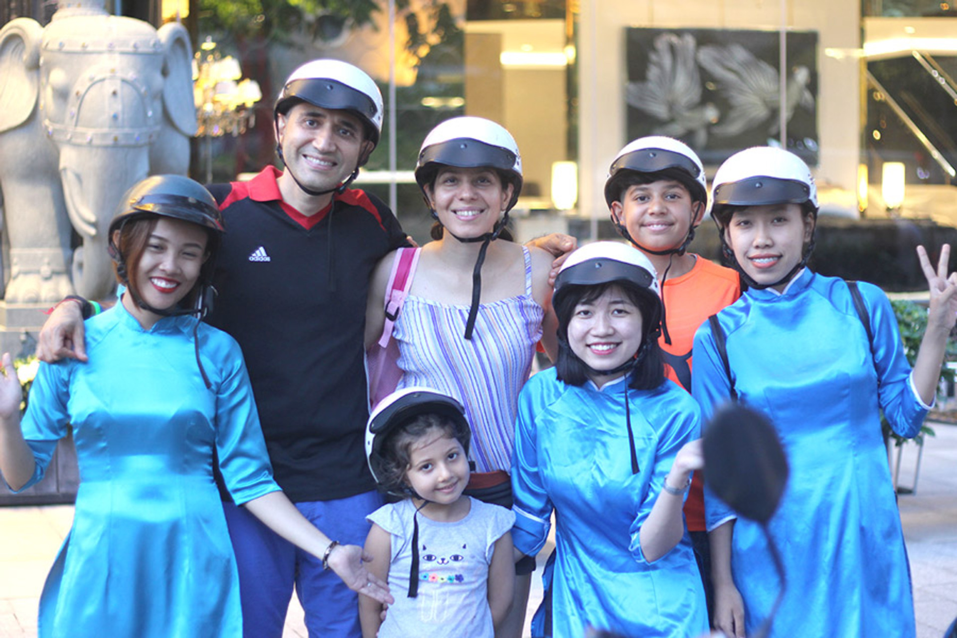 family with children during a saigon city tour by motorbikes
