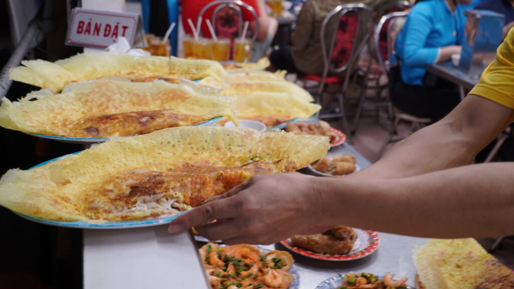 Crispy Vietnamese pancakes served fresh at a bustling local eatery
