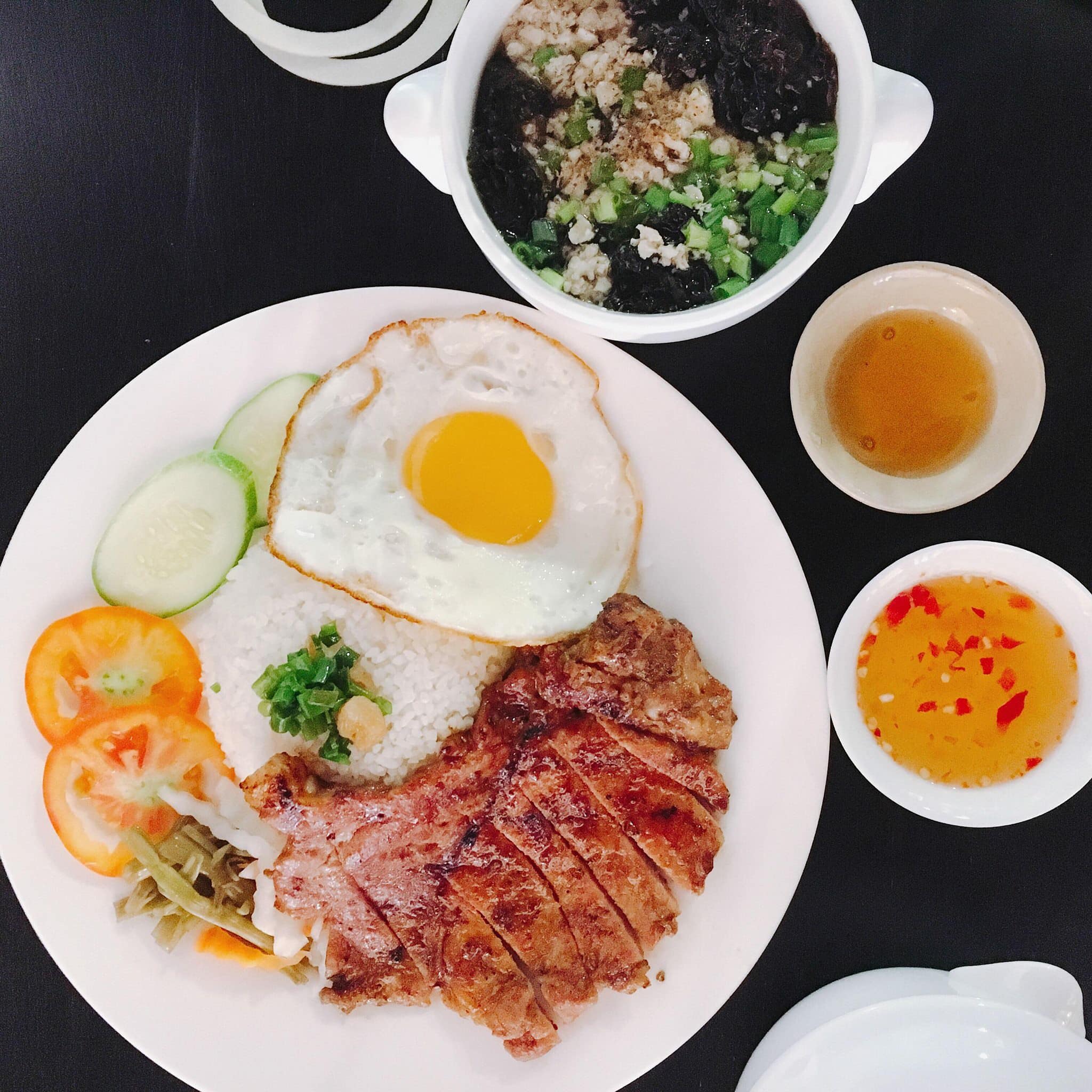 Broken rice with grilled pork chop, fried egg, and dipping sauce