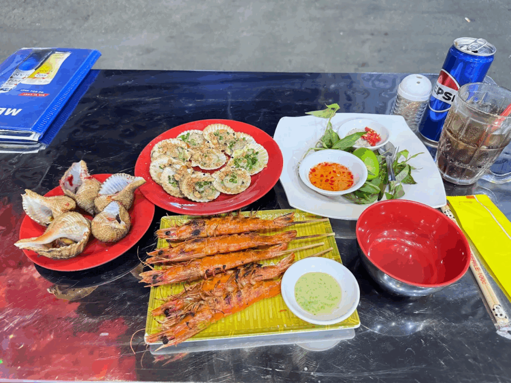 Grilled shrimp, scallops, and cockles served street-style in Ho Chi Minh City