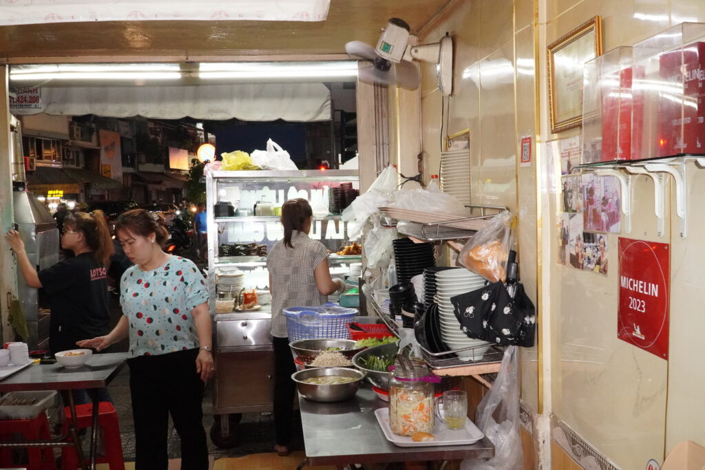 Bustling kitchen space of a Michelin-recognized Vietnamese street food eatery