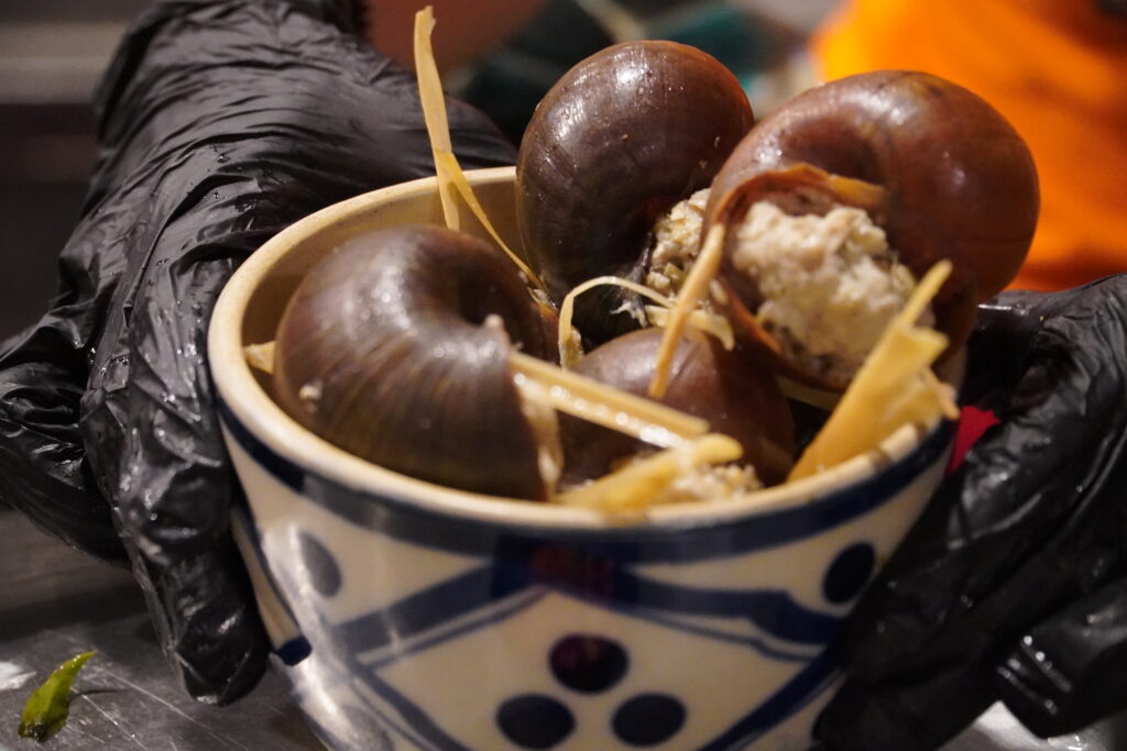 Steamed Vietnamese stuffed snails with minced pork and lemongrass in a ceramic bowl