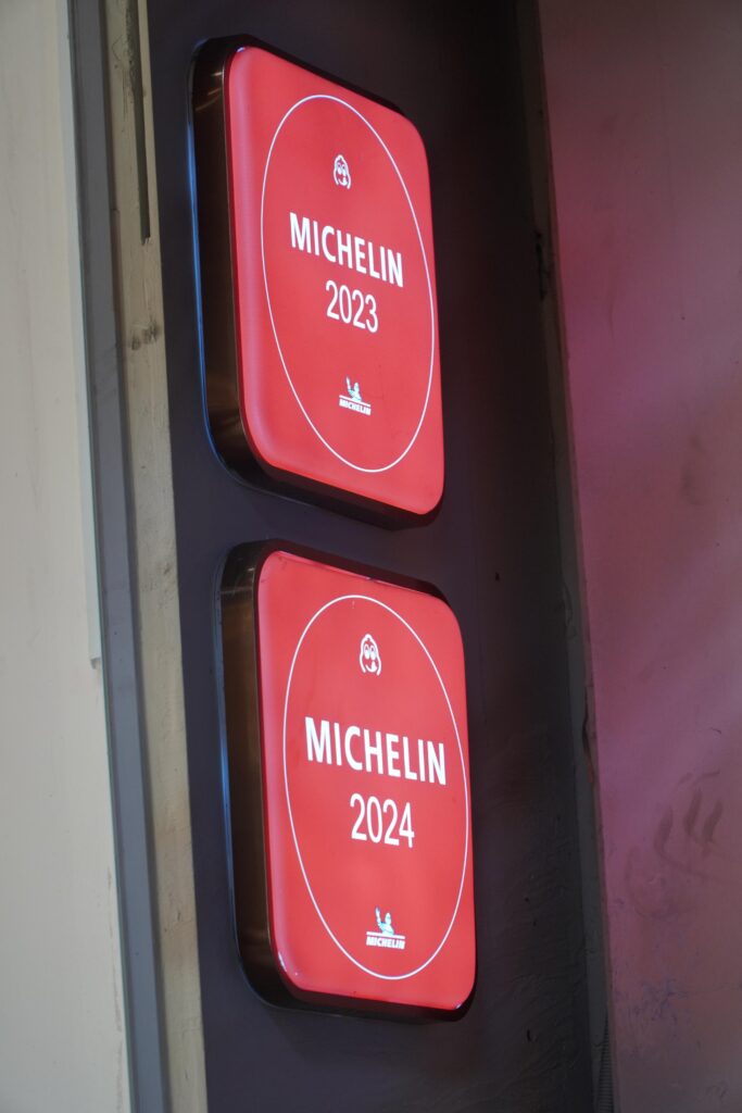 Michelin Guide plaques for 2023 and 2024 displayed at a recognized Vietnamese restaurant