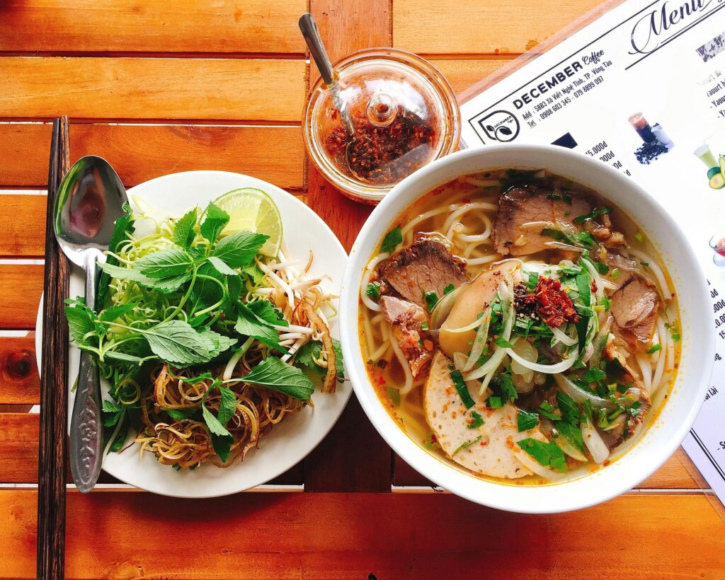 Spicy Hue-style beef noodle soup with fresh herbs which recommend by Michelin Guide