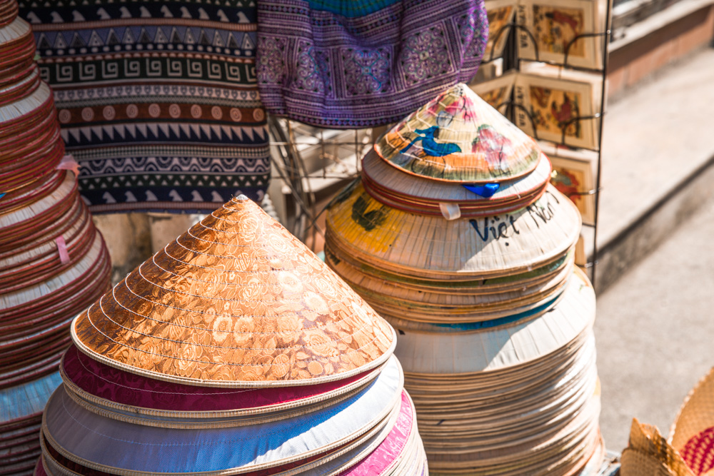 Colorful stacks of traditional Vietnamese conical hats (nón lá) which is special souvenir gift from Vietnam