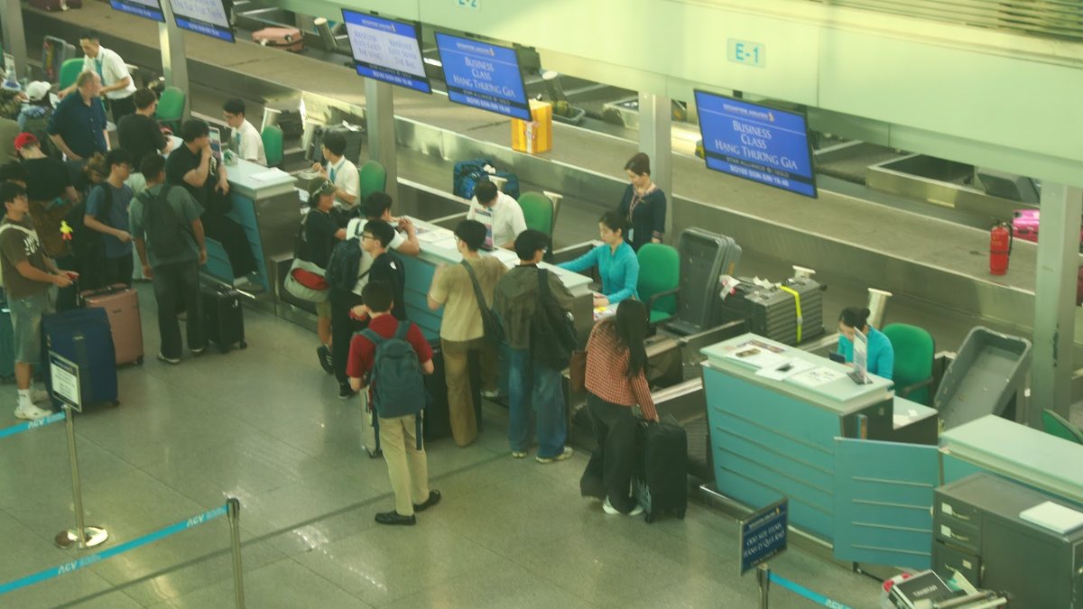 Crowded airport check-in hall in Vietnam during a busy arrival and departure window