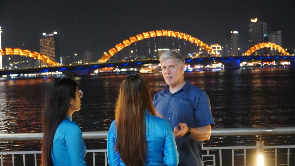 Da Nang at night: the Dragon Bridge lit up over the Han River with KissTour guests