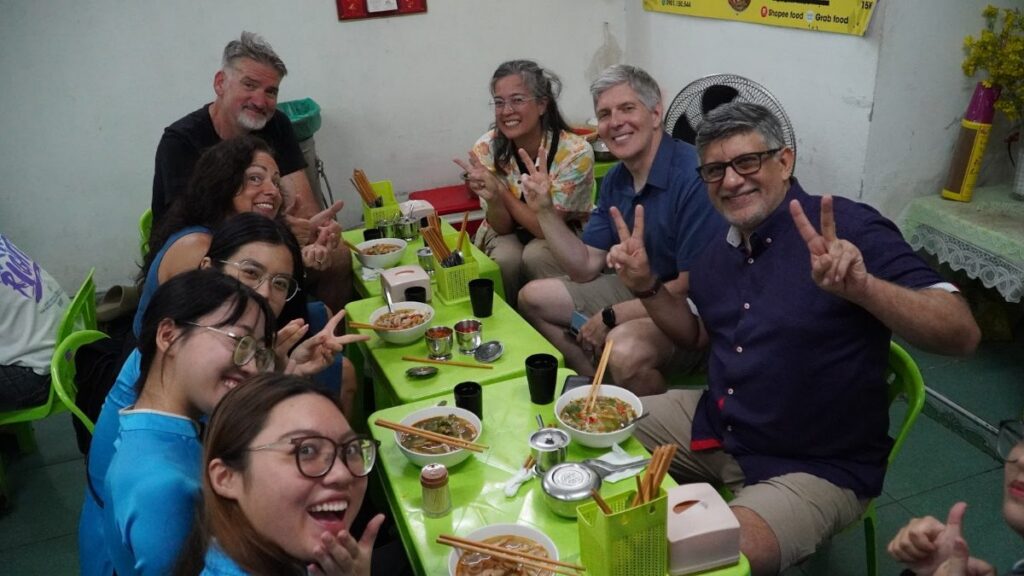 Da Nang food tour group sharing local street food dishes
