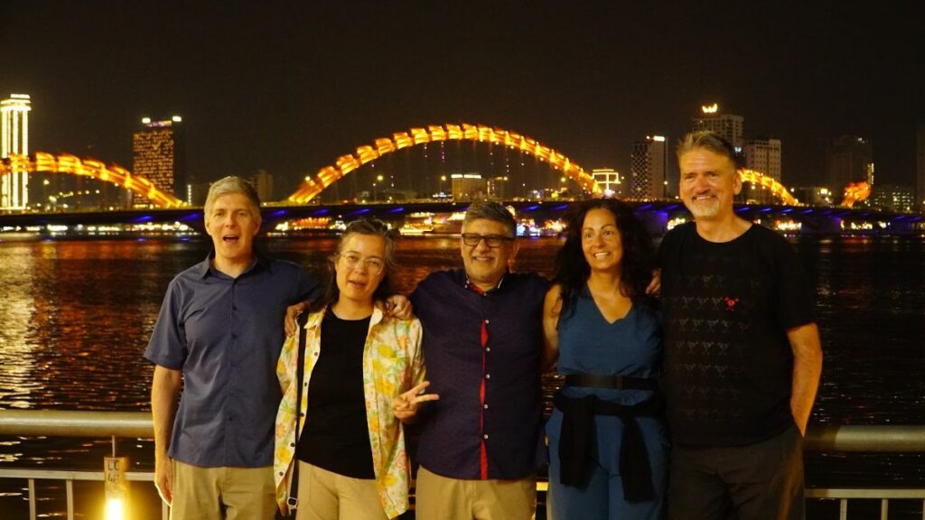 KissTour guides and guests in front of the lit Dragon Bridge, the stop that makes a Da Nang night tour worth it