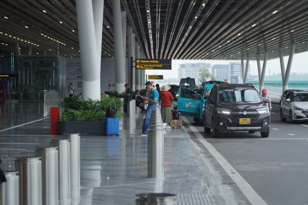 Travelers at Tan Son Nhat Airport arrivals pickup area with no Vietnam health declaration checks