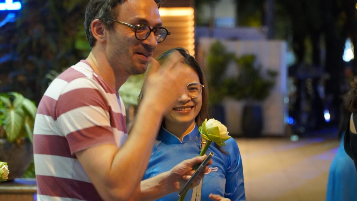 Which Saigon tour is right for you - a KissTour guide in blue ao dai laughing with a guest