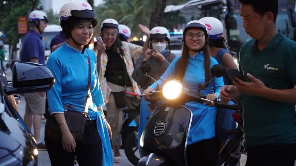 KissTour riders on scooters, Da Nang palm-lined street