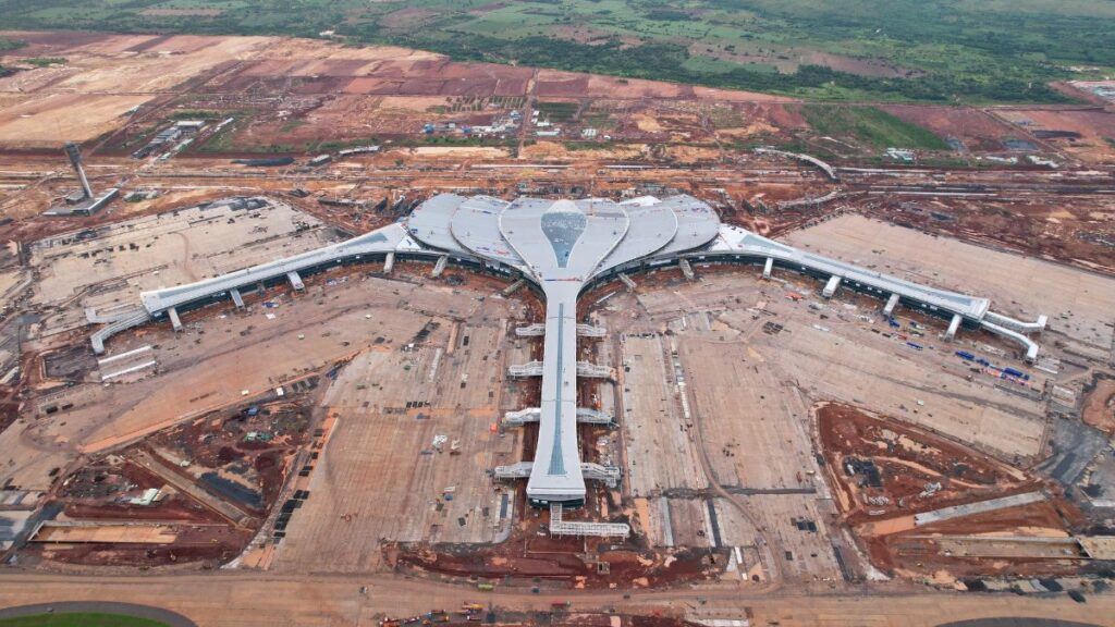 Long Thanh International Airport terminal seen from the air, its lotus-leaf roof finished ahead of the first flight