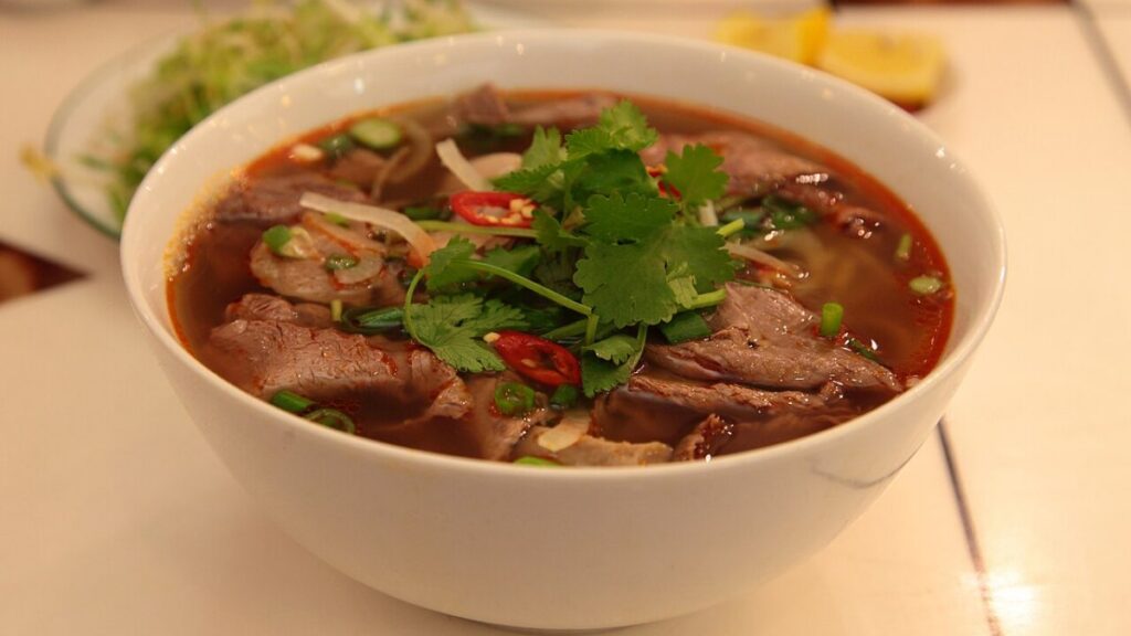 Bun bo hue, a spicy beef noodle soup, served in a bowl in Saigon