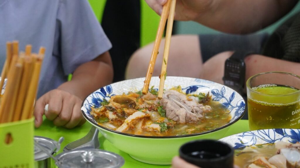 A steaming bowl of noodles at a Da Nang street-food eatery, the home of Mi Quang