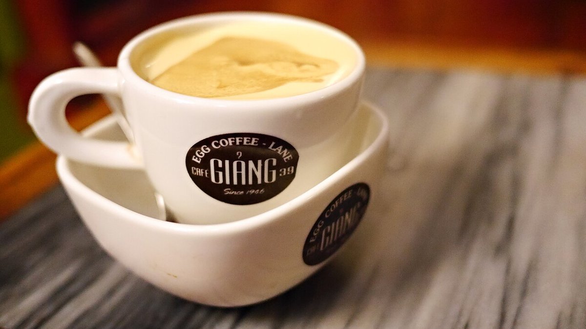 A cup of Hanoi egg coffee topped with whipped egg cream