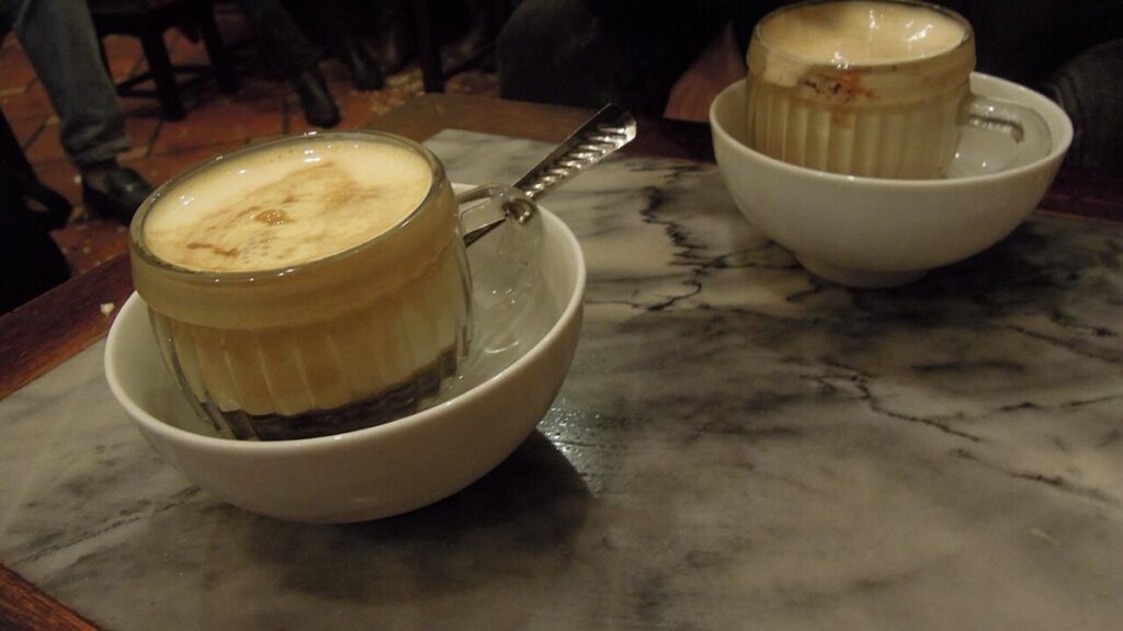 Egg coffee in Hanoi served in a cup kept warm in a bowl of hot water
