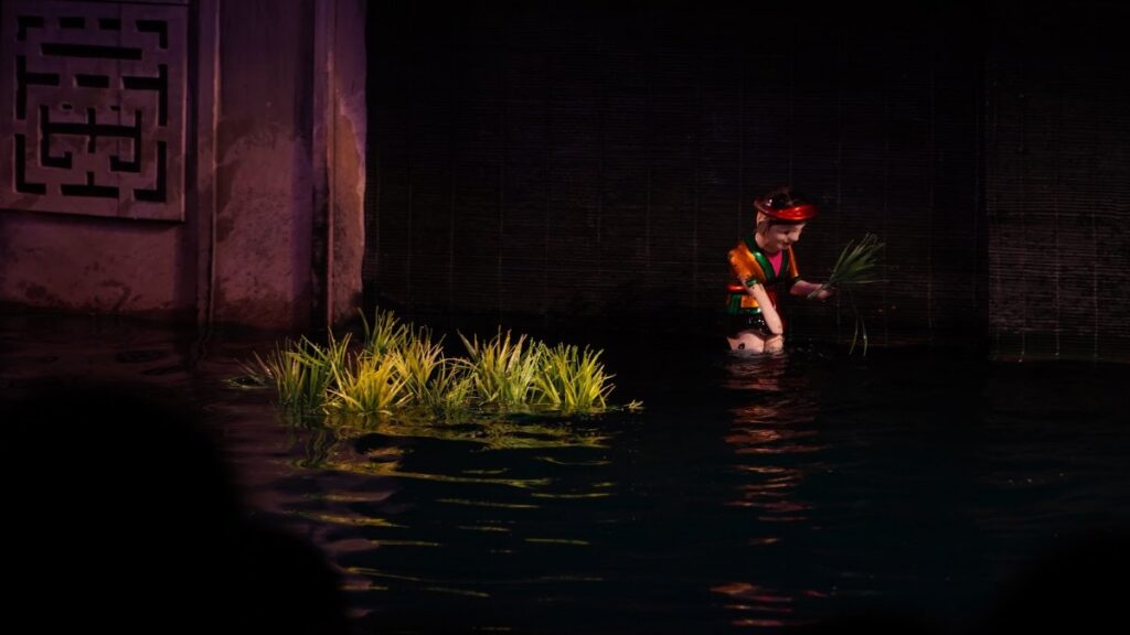 Water puppets performing on water at a Hanoi theatre in the evening