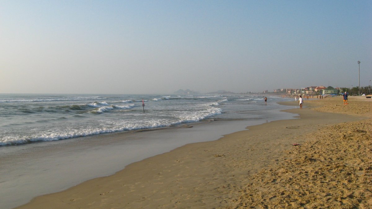 Waves rolling onto the sandy shore of My Khe Beach, Da Nang