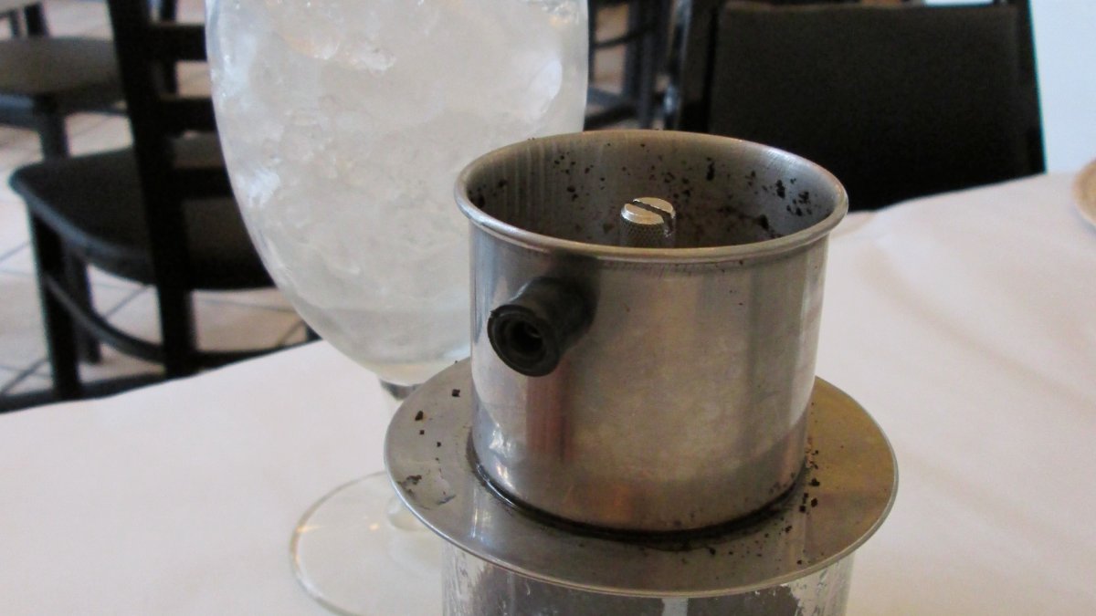 Coffee dripping through a traditional Vietnamese phin filter